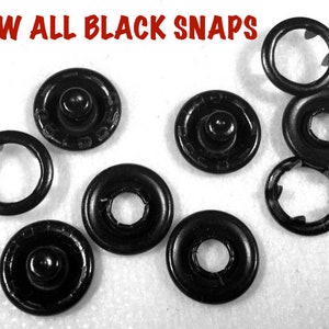 May include: Eight black metal snaps, some are separated into two pieces, showing the inner workings of the snap.