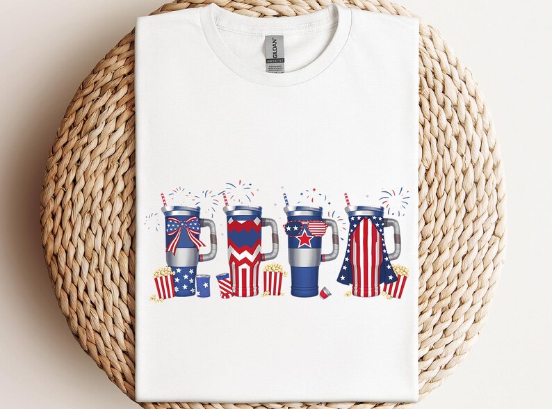 a white t - shirt with fireworks and stars on it