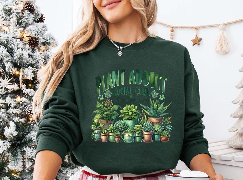 a woman wearing a green sweatshirt with plants on it