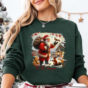 a woman wearing a christmas sweater holding a remote control