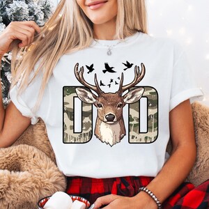 a woman wearing a t - shirt with a deer on it