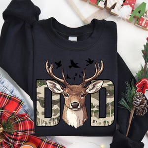 a black t - shirt with a deer head on it