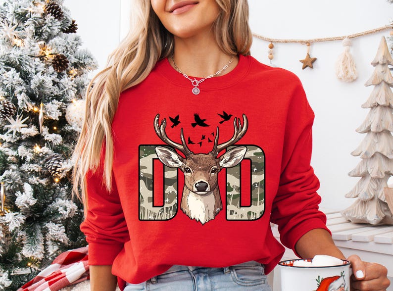 a woman wearing a red sweatshirt with a deer on it