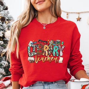 a woman in a red sweatshirt holding a coffee mug