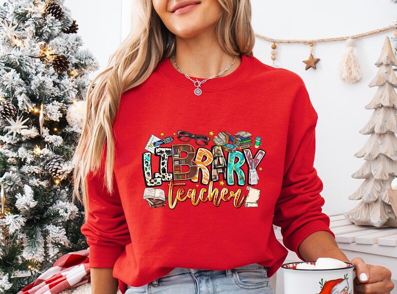 a woman in a red sweatshirt holding a coffee mug