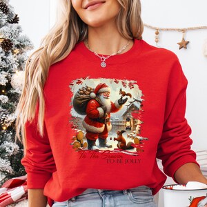 a woman wearing a santa clause sweater holding a coffee mug