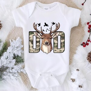 a white bodysuit with a deer head on it
