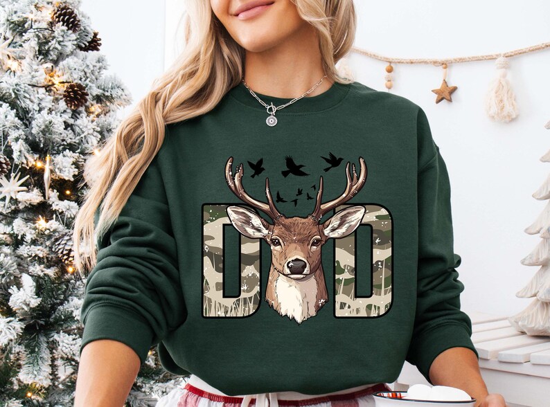 a woman wearing a green sweatshirt with a deer on it