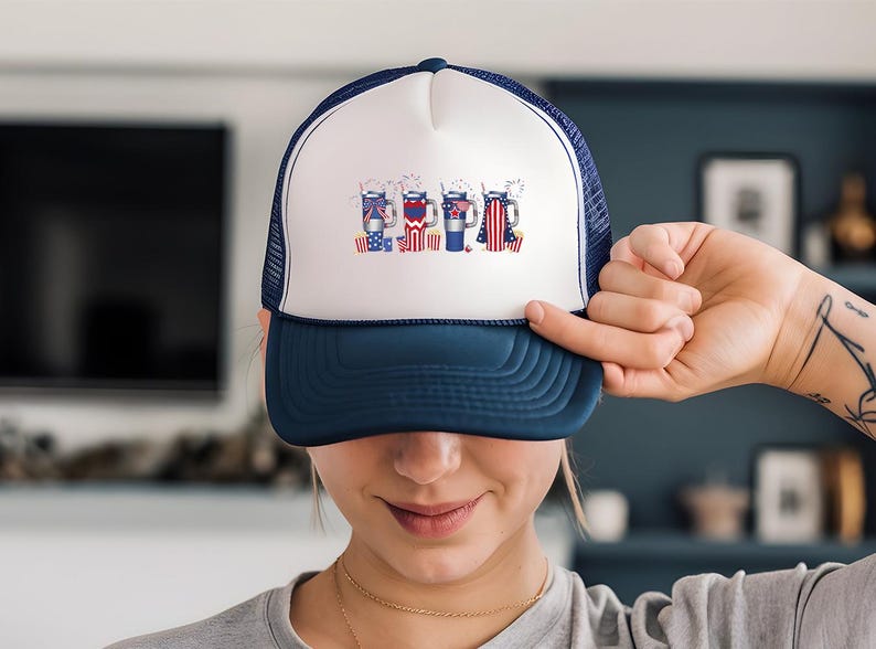 a woman holding up a hat with a picture on it