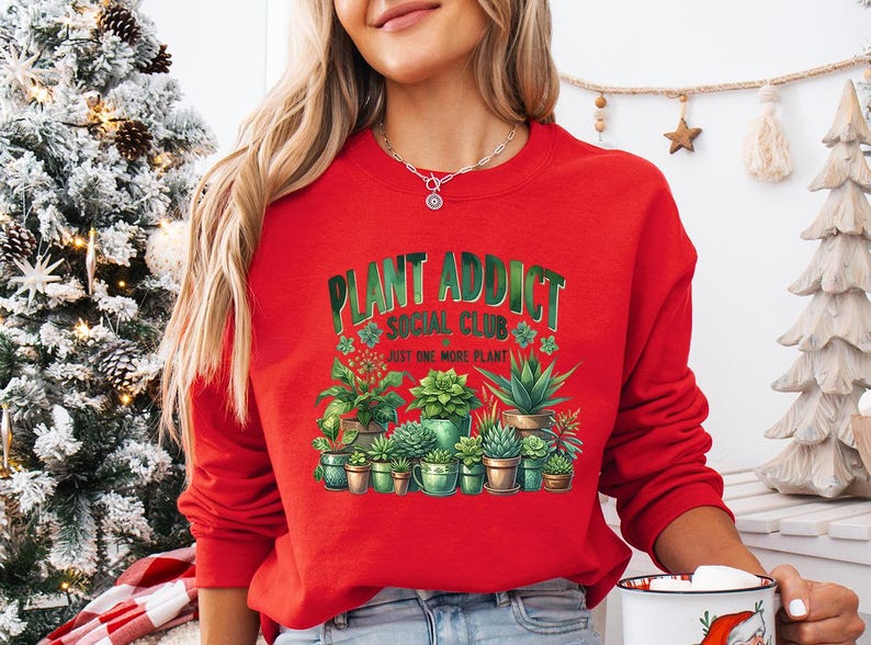 a woman in a red sweatshirt holding a coffee mug