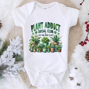 a baby bodysuit with plants on it