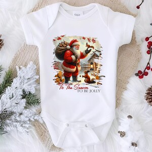 a white baby bodysuit with a santa clause on it