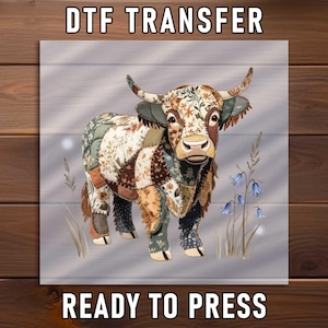 May include: A DTF transfer featuring a patchwork Highland cow design. The cow has a brown and white face, with floral patterns on its body. The text "DTF TRANSFER" and "READY TO PRESS" are displayed in white.