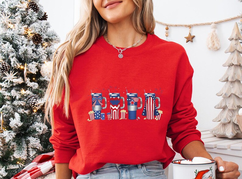 a woman in a red sweater holding a cup of coffee