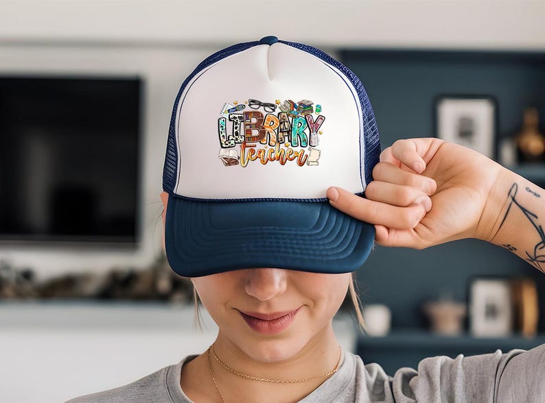 a woman holding a hat with the word happy birthday written on it