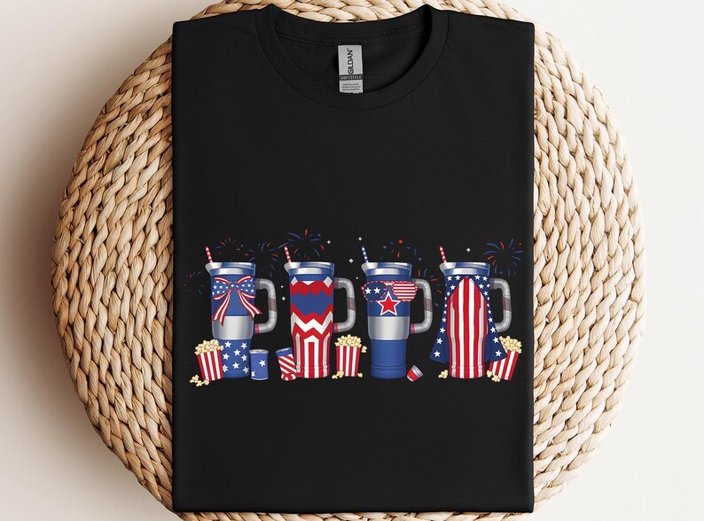 a black t - shirt with fireworks and american flags on it