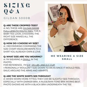 May include: A white Gildan 5000B youth t-shirt with short sleeves and a crew neckline. The text on the image provides sizing information, including Q&A about the fit, length, and transparency of the shirt, noting the wearer is in a size small.