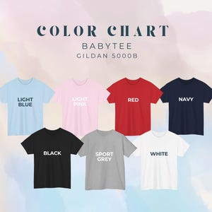 May include: A color chart for Gildan 5000B baby tees featuring seven short-sleeve t-shirts in light blue, light pink, red, navy, black, sport grey, and white. Each shirt is labeled with its corresponding color name in bold text.