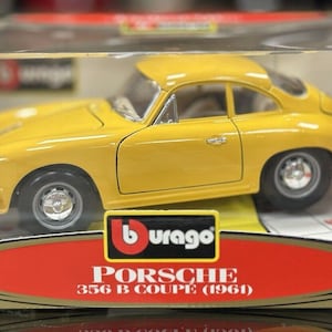May include: A yellow 1/18 scale Burago diecast model car of a Porsche 356 B Coupe (1961).