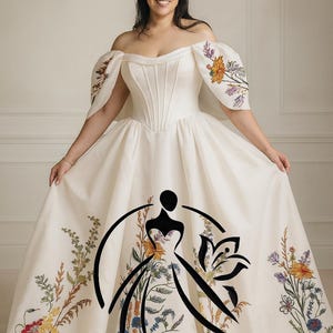 May include: Off-white bridal gown with floral embroidery. The dress features an off-the-shoulder neckline, a fitted bodice, and a full skirt. The sleeves are adorned with colorful floral designs, and the skirt has a floral pattern. The text "Hana Novias BRIDAL" is visible.