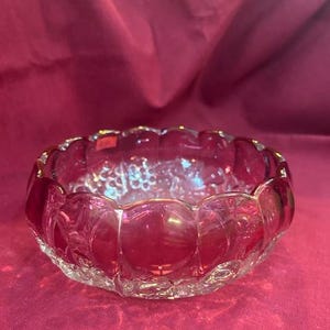 Cranberry Glass bowl with scalloped edges and fruit pattern
