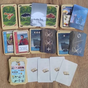 Cartas CATAN para la expansión Comerciantes y Bárbaros, CATAN - La Leyenda de los Ladrones del Mar y CATAN - La Leyenda de los Conquistadores / 2-4 y 2-6 jugadores