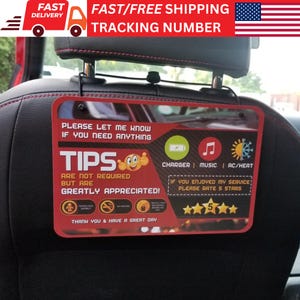 May include: Red and white sign with the text "Please let me know if you need anything" and "Tips are not required but are greatly appreciated!" The sign also includes icons for charger, music, AC/heat, and a 5-star rating system. The sign is designed to be hung on the back of a car seat.