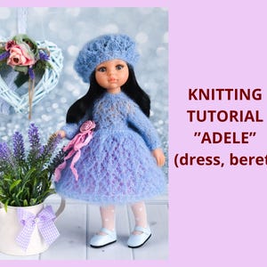 May include: A doll wearing a knitted blue dress and beret, with a pink ribbon and white shoes. The image includes text that reads "KNITTING TUTORIAL 'ADELE' (dress, beret)". A white watering can with lavender and a heart-shaped wreath are in the background.
