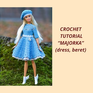 May include: A doll wearing a light blue crochet dress and matching beret. The dress features a detailed bodice and a flared skirt with white trim. The doll is also wearing white boots. The text on the right says "CROCHET TUTORIAL 'MAJORKA' (dress, beret)".