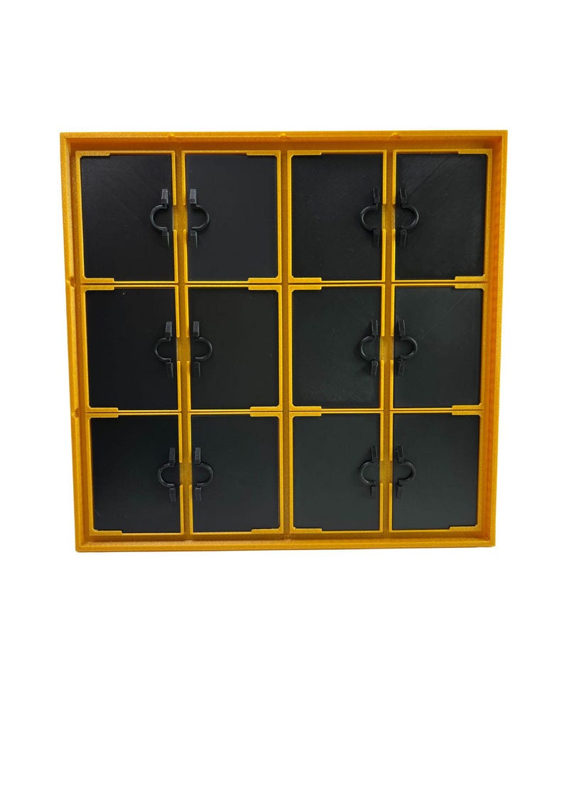 May include: A yellow and black plastic storage container with a grid of twelve compartments. Each compartment has a black door with a small, black handle. The container is designed for organizing small items.