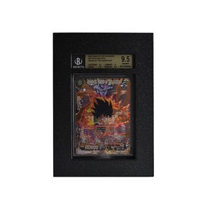 May include: A graded trading card featuring a colorful illustration of a character from Dragon Ball Z. The card is encased in a black holder with a Beckett Grading Services label, indicating a grade of 9.5. The card's details are visible.