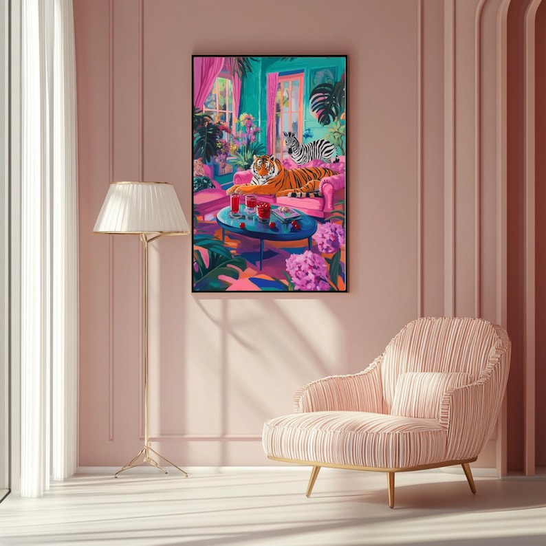 May include: A framed art print depicts a vibrant interior scene. A tiger and zebra relax on a pink sofa, surrounded by tropical plants and a small table with drinks. The artwork features bright colors and a whimsical style.