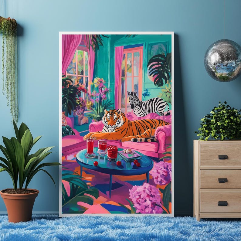 May include: A vibrant art print featuring a tiger and zebra lounging in a colorful room. The artwork showcases a pink sofa, a blue table with drinks, and lush plants. The color palette includes pink, teal, and orange.