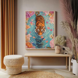 Pode incluir: Uma impress&atilde;o art&iacute;stica emoldurada com um tigre nadando em uma piscina cercada por flores. O tigre tem listras laranja e pretas. A &aacute;gua &eacute; azul clara com p&eacute;talas de flores cor-de-rosa.