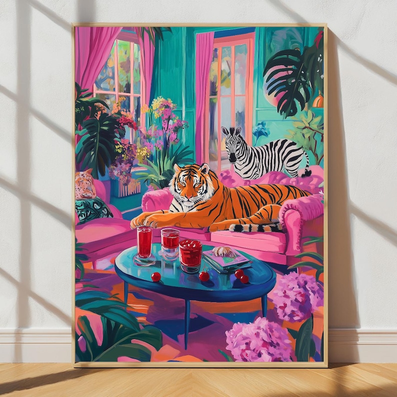 May include: A vibrant art print depicts a tiger lounging on a pink sofa with a zebra in a colorful room. The scene includes a blue table with drinks, flowers, and lush greenery, creating a whimsical and exotic atmosphere.