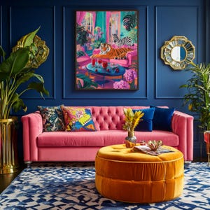 May include: A vibrant living room scene with a pink tufted sofa, an orange ottoman, and a blue patterned rug. A framed artwork depicts a tiger and zebra. Decorative pillows and plants add color. Gold accents and a blue wall complete the decor.