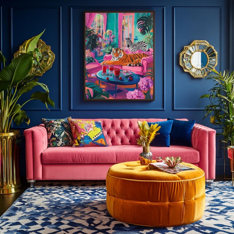 May include: A vibrant living room scene with a pink tufted sofa, an orange ottoman, and a blue patterned rug. A framed artwork depicts a tiger and zebra. Decorative pillows and plants add color. Gold accents and a blue wall complete the decor.