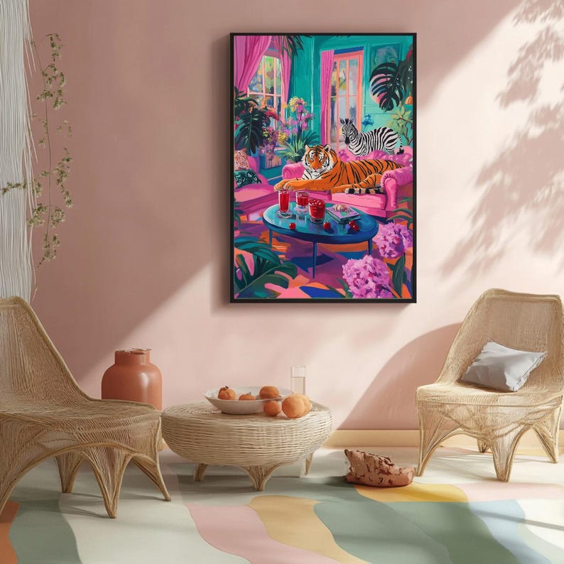 May include: A framed art print depicts a vibrant interior scene with a tiger and zebra lounging on a pink sofa. A round blue table holds drinks. Lush plants and pink curtains frame the scene, creating a colorful, whimsical aesthetic.