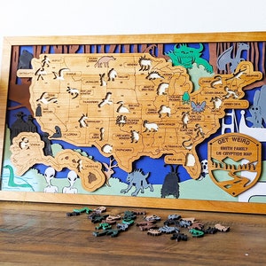 May include: A wooden map of the United States with cutouts of various cryptids, including the Jersey Devil, Mothman, and the Beast of Bray Road. The map is labeled "Get Weird Smith Family US Cryptids Map".