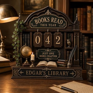 May include: A dark wood book tracker display featuring the text BOOKS READ THIS YEAR, JUST ONE MORE CHAPTER, and EDGAR'S LIBRARY. It includes three hanging number tiles showing 042, a miniature globe, a candle, an open book, and a quill pen.