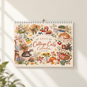 May include: A 2027 Cottage Cats calendar featuring illustrations of cats, flowers, books, a straw hat, a basket of apples, pumpkins, and garden tools. The text reads 2027 Cottage Cats Calendar, surrounded by colorful seasonal motifs.