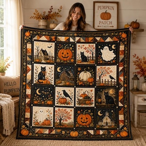 Könnte beinhalten: Ein großer quadratischer Quilt mit einem Raster aus sechzehn Feldern, die Halloween-Motive wie Kürbisse, schwarze Katzen, Geister, Krähen, Scheunen und Häuser zeigen. Der Quilt hat einen dunklen Rand mit orangefarbenen Kürbismustern.
