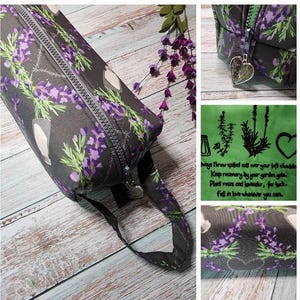 May include: A gray zippered pouch with a lavender and rosemary print. The pouch has a black strap and a zipper pull with a heart charm. The text on the pouch reads: "Always throw spilled salt over your left shoulder. Keep rosemary by your garden gate. Plant roses and lavender, for luck. Fall in love whenever you can."