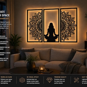 May include: A triptych of black laser-cut wall art with a mandala design and a meditating figure, illuminated by warm LED backlighting. The artwork is framed and mounted above a sofa, with text that reads "ELEVATE YOUR SPACE WITH HARMONY".
