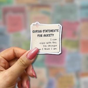 May include: A sticker with the text "GOPING STATEMENTS FOR ANXIETY". The sticker has a light beige background with a paperclip at the top. The text reads "I can cope with this. I'm stronger than I think I am."
