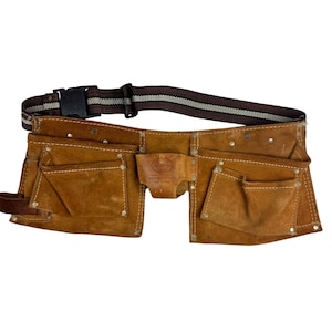 May include: A brown leather tool belt with multiple pockets and a brown and white striped adjustable strap. The belt has a black plastic buckle and a small leather pouch in the center.