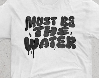 Must Be The Water. Unisex crewneck T-shirt for Formula 1 fans. F1 merch. Formula One. Charles Leclerc Radio Message. Funny motorsport shirt