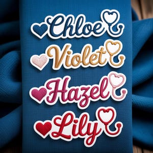May include: Four embroidered name patches: "Chloe" in navy, "Violet" in gold, "Hazel" in magenta, and "Lily" in red. Each name is paired with a heart and a stethoscope design, all on a blue fabric background.