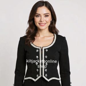 May include: A black jacket with silver trim and diamond-shaped studs. The jacket features a rounded neckline and long sleeves. The text "kiltjacketsonline shop" is displayed on the front of the jacket.
