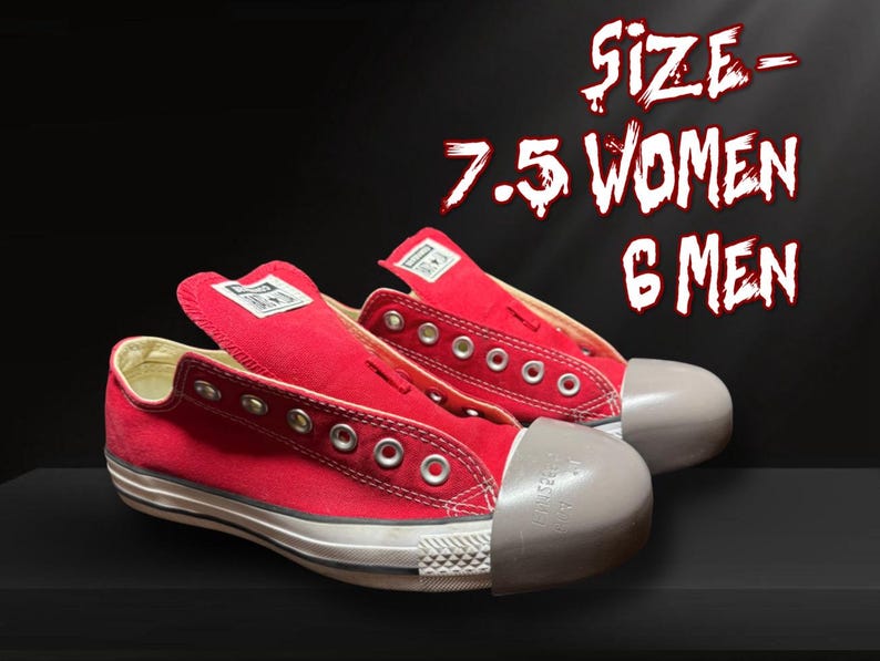 May include: Pair of red canvas trainers with white soles and toe caps. The trainers have metal eyelets and a white label on the tongue. The text on the image reads "SIZE - 7.5 WOMEN 6 MEN".
